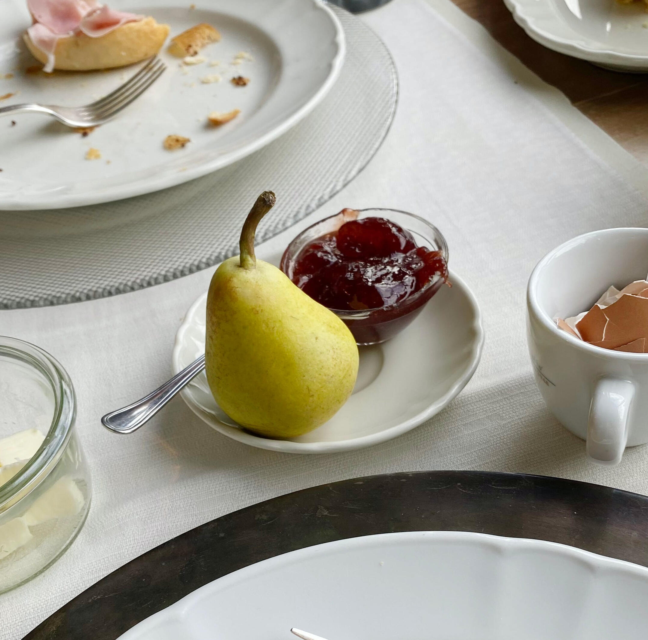 Image of a pear and jam with an empty plate in the background for Peppermint Tea and Pie