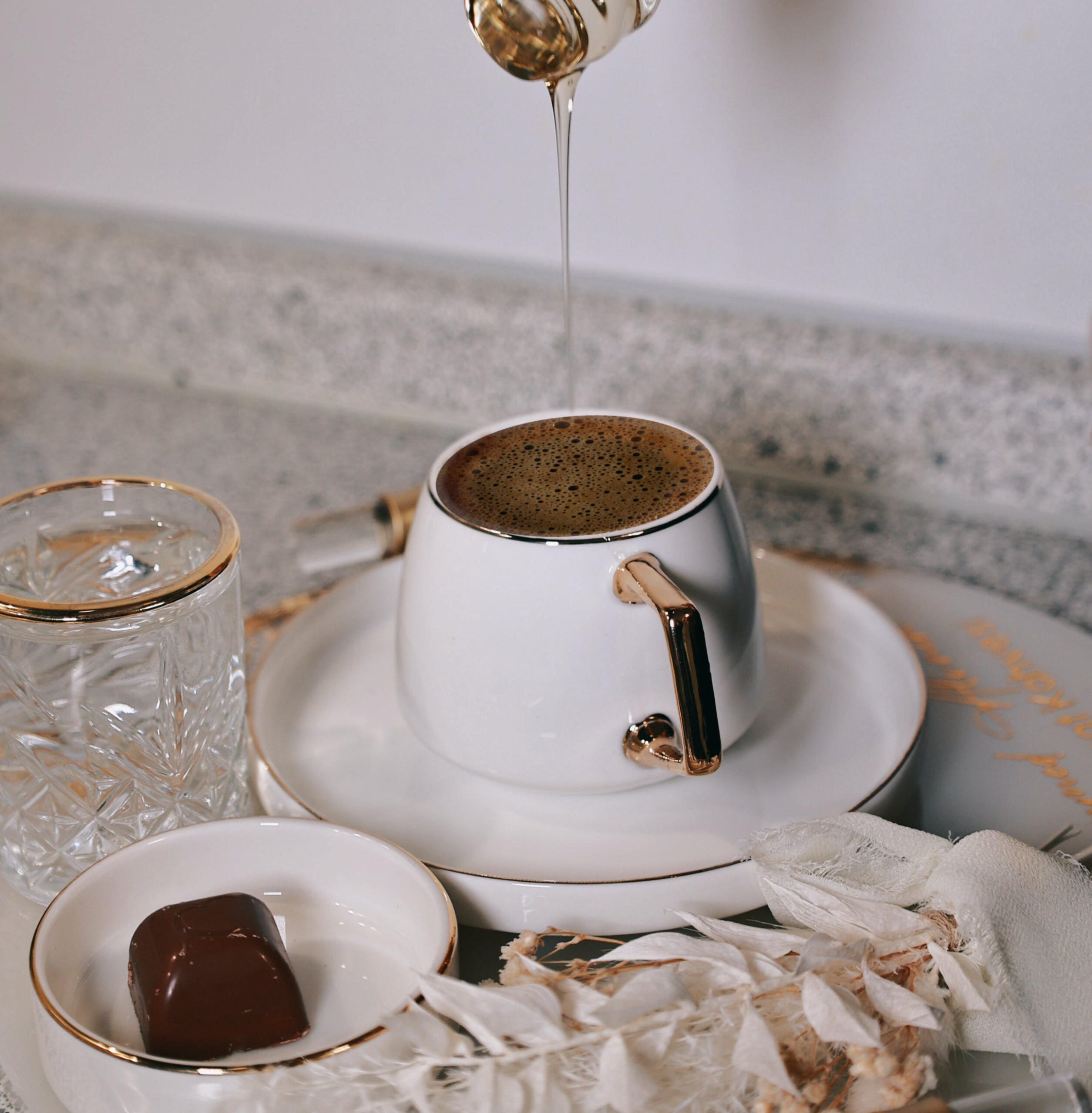 photo of honey being added to a hot cup of dark bubbly tea for the Peppermint Tea and Pie group